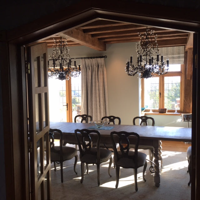 Stunning dining room with embroidered curtains, blinds and chandeliers...