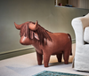 An Omersa Highland Cow Footstool